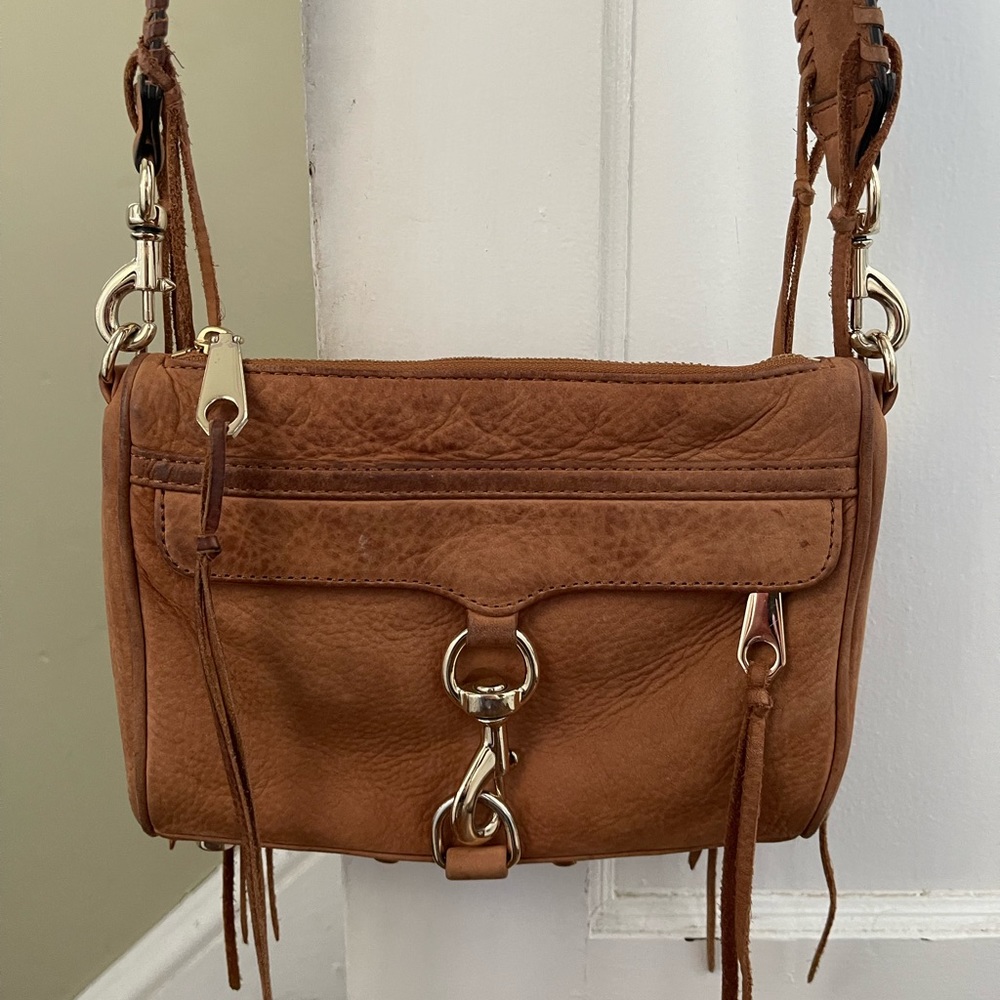 Tan Rebecca minkoff bag with guitar strap, worn but in great condition.